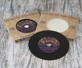 Retro wedding invite CDs in record-style wallets with black vinyl discs