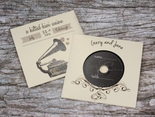 Wedding invite CDs in white gold metallic record-style wallets with black vinyl discs